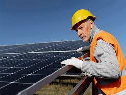 Man installing solar panels on building site.